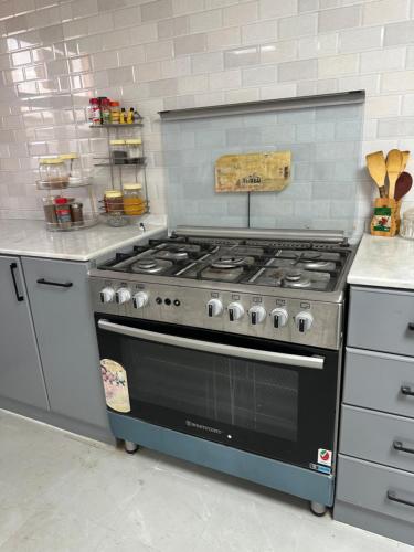 a kitchen with a stove top oven in a kitchen at Farm house with all facilities in Al Dhaid , sharjah in á¸¨aÅŸat al BidÄ«yah