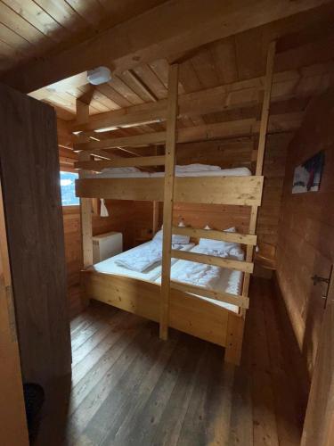 a room with two bunk beds in a cabin at Almhüttendorf Klippitztörl in Klippitztorl