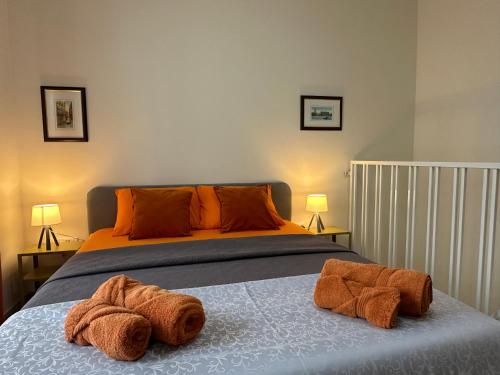 a bedroom with a bed with two towels on it at DoMiSol duplex suites near sea in St. Paul's Bay