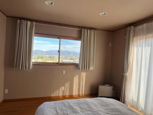 Ένα ή περισσότερα κρεβάτια σε δωμάτιο στο Cozy House Azumino