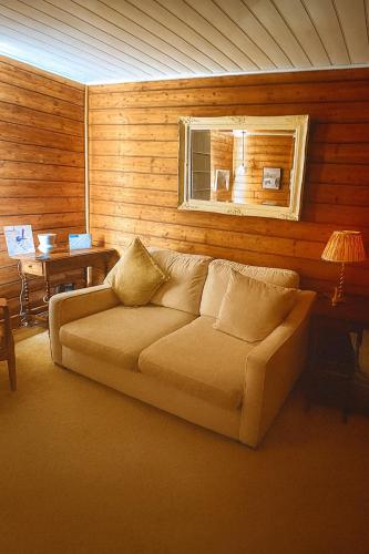 a living room with a couch and a window at Oakchester Cottage on Bruny Island in Killora