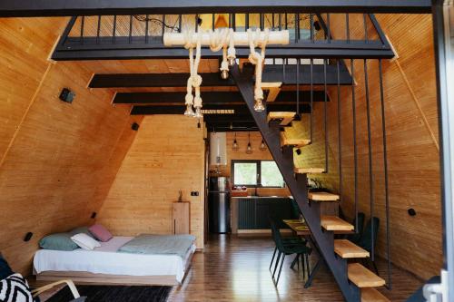 a room with a bunk bed and a staircase at A-Forest Retreat - David's A-frame in Ocna-Mureşului