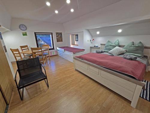 a bedroom with a large bed and a dining room at Turistična kmetija Sušek in Muta