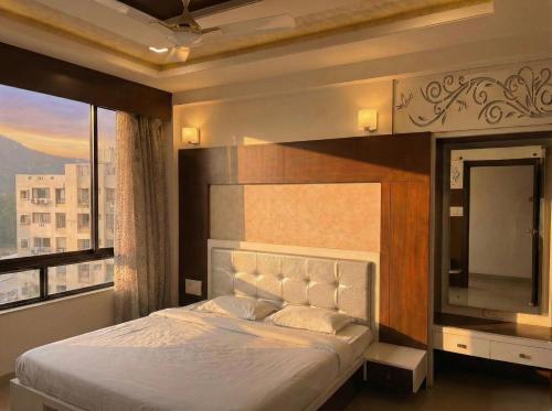 Un dormitorio con una cama grande con una ventana grande. en Avasa Homestay, en Thūr