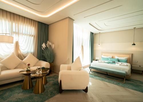 a hotel room with a bed and a couch at Le Royal Plaza in Kenitra