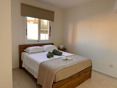 a bedroom with a large bed with a window at Tersefanou Retreat Studio Apt in Tersephanou