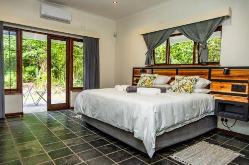 a bedroom with a large bed with a wooden headboard at House 1967 in George