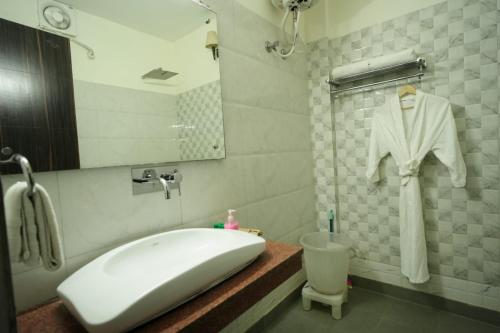 a bathroom with a sink and a bath tub at Exotic resort in Gaushala