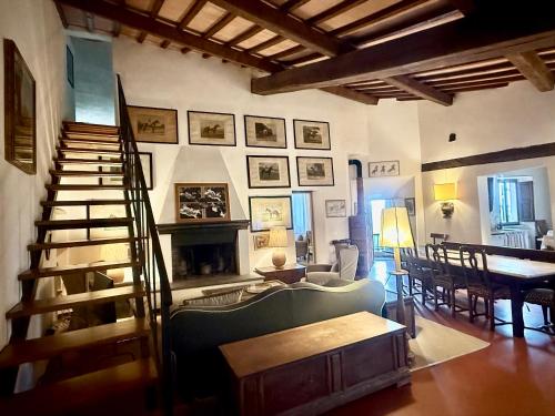 a living room with a staircase and a couch and a table at Casa Giovanna in Montemerano