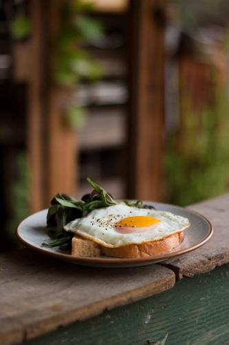 ein Spiegelei auf einem Stück Brot auf einem Teller in der Unterkunft Saigon Eliot Hotel 11 in Ho-Chi-Minh-Stadt