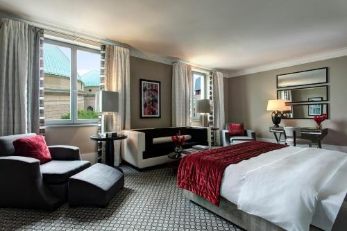 a hotel room with a bed and a living room at Hotel De Rome Berlin in Berlin