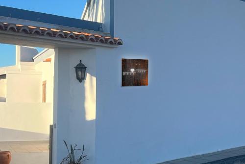 a white building with a light on the side of it at YucaJaus in Teguise