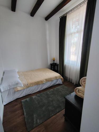 a bedroom with a bed and a window at T38 Apartment, Vatra Dornei in Vatra Dornei