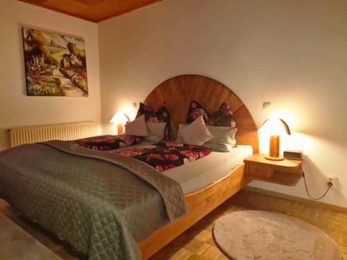 a bedroom with a large bed with a wooden headboard at Feriendomizil 219 in Allerheiligen bei Wildon