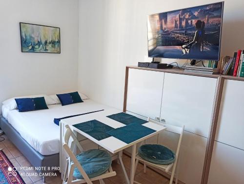 a small room with a bed and a table and a tv at Lovely view in Nice