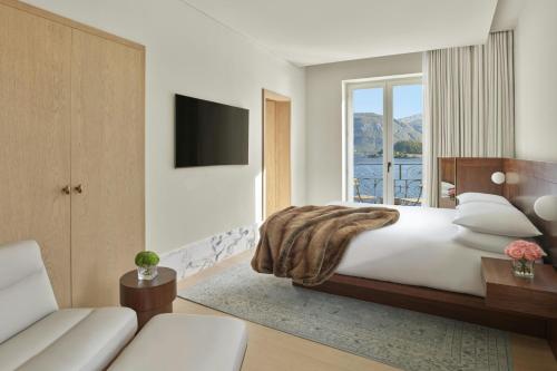 a bedroom with a large bed and a window at The Lake Como EDITION in Griante Cadenabbia