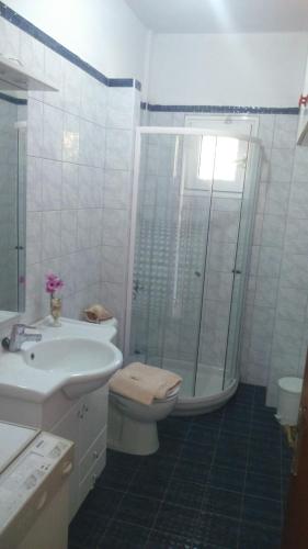 a bathroom with a toilet and a sink and a shower at Trizinia View in Galatas