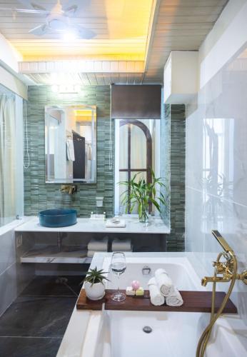 a large bathroom with a tub and a sink at Hotel Lake Shilloi in Dimāpur