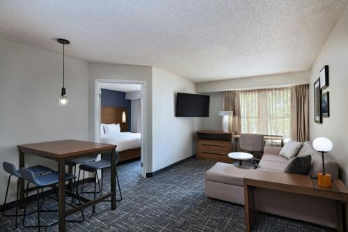 a hotel room with a couch and a table at Residence Inn by Marriott Houston The Woodlands/Lake Front Circle in The Woodlands