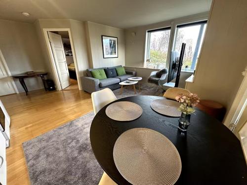 a living room with a table and a couch at Aurora Borealis Apartment - Sleeps 3 - Parking in Hjorten
