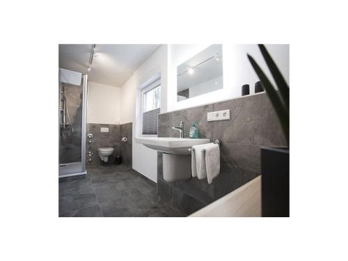 a bathroom with a sink and a toilet at Q-Stall, Apartment 05 in Brilon