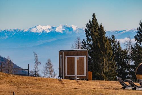 a small cabin on top of a hill with mountains at Rallentare immersi nel verde di Cima Lan 