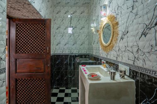 a bathroom with a sink and a mirror at Riad HAFSSA & Spa in Marrakech