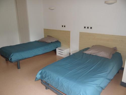 Ένα ή περισσότερα κρεβάτια σε δωμάτιο στο Les Cinq Chemins, Etape et Séjour inclusif au coeur des Volcans d'Auvergne