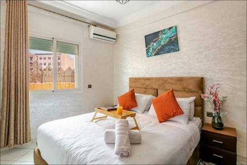 a bedroom with a bed with a table on it at Cocon Chic et Élégant Quartier Hivernage in Marrakech