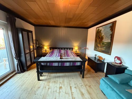 a bedroom with a bed with a wooden ceiling at Pölstaler Berghütte in Oberzeiring