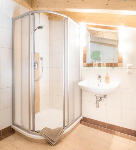 a bathroom with a shower and a sink at Voglbach, Bauernhof in Rauris