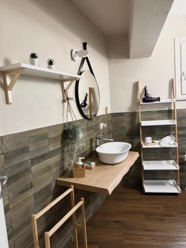 a bathroom with a bowl sink on a wooden counter at Borgo Nocchiara in Carlentini