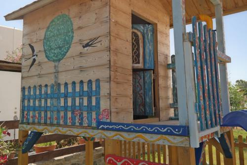 a wooden play house with a window at Annio studios in Plaka