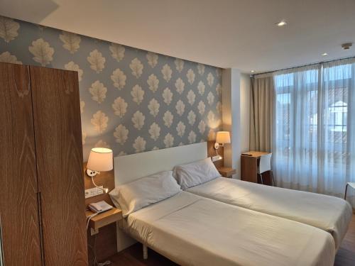 Ένα ή περισσότερα κρεβάτια σε δωμάτιο στο Deniké Grupo Atalaia