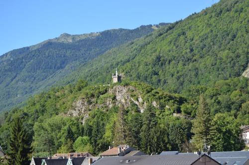 a castle on top of a hill in the mountains at Hôtel Le Bellevue in Ax-les-Thermes