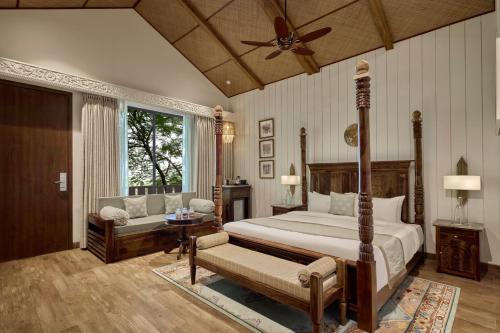 a bedroom with a bed and a ceiling fan at WelcomHeritage Akashganga Heritage Hills Resort & Spa 