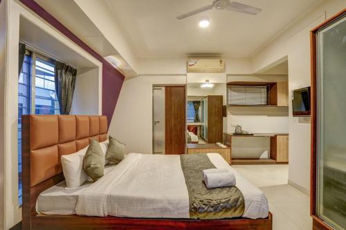 a bedroom with a large bed in a room at Hotel Orchard Nest - Pune Sinhgad Road in Pune