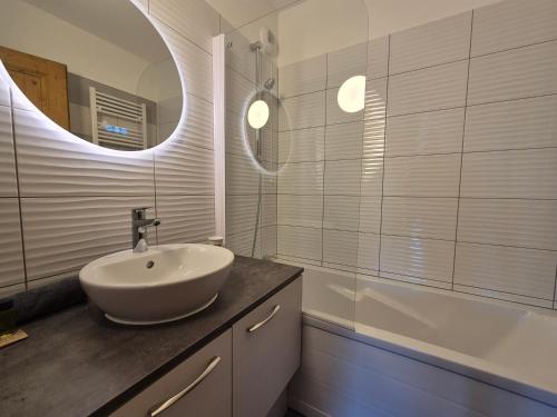 a bathroom with a sink and a mirror and a tub at Élégant Duplex - Sainte Foy Station - 10 pers in Sainte-Foy-Tarentaise