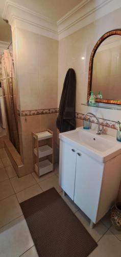 a bathroom with a sink and a mirror at Riad Diaz Taghazout in Taghazout