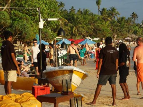 a group of people standing on a beach at Private Beach House in Mirissa in Mirissa