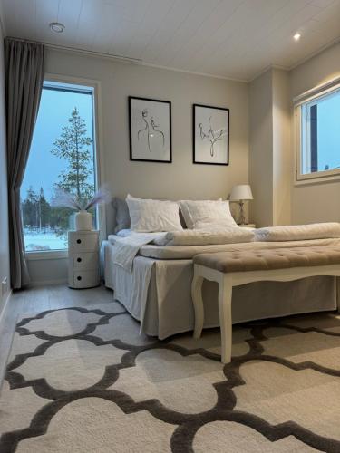 a bedroom with a large bed with a large window at Villa Hattara in Rovaniemi