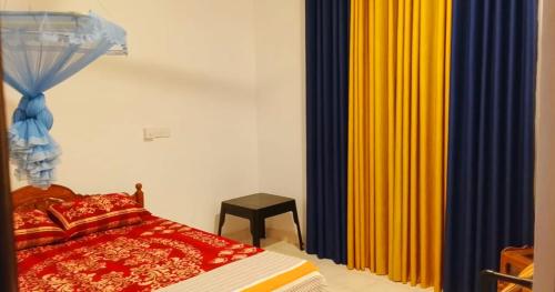 a bedroom with a bed and colorful curtains at Private Beach House in Mirissa in Mirissa
