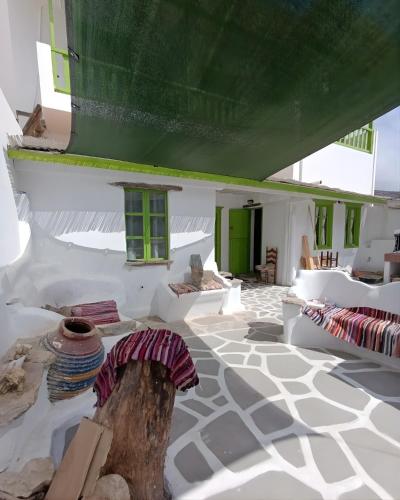 a room with white walls and a green roof at Aegaia Residencies in Katapola