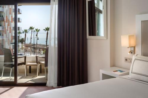 a hotel room with a bed and a balcony at Melia Costa del Sol in Torremolinos