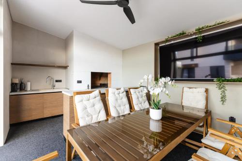 a kitchen and living room with a wooden table and chairs at Luxury Villa Positiva in Vir