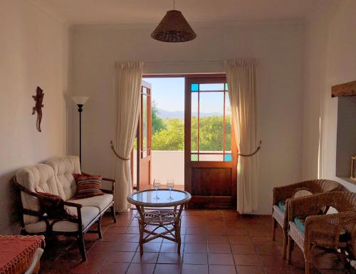 a living room with a couch and a table at Eensgevonden Vineyard Cottages in Rawsonville