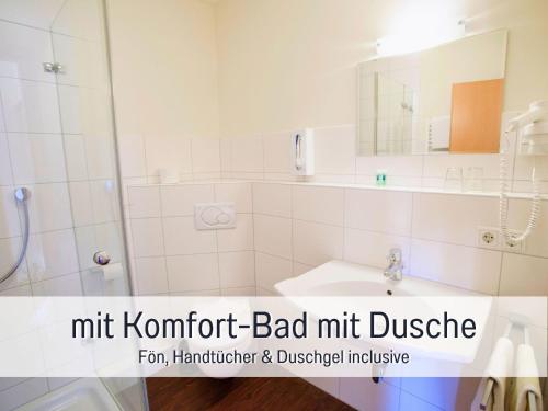 a bathroom with a sink and a shower and a mirror at Landgasthof Linde - In ruhiger, ländlicher Umgebung in Deggenhausertal