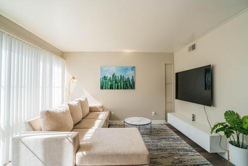 a living room with a couch and a tv at Spacious 2 Bedroom, 2 Bath, Pool, Free Parking, Gym in Scottsdale