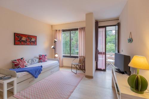 a bedroom with a bed and a desk and a window at Lido I Palmizi in Capoliveri