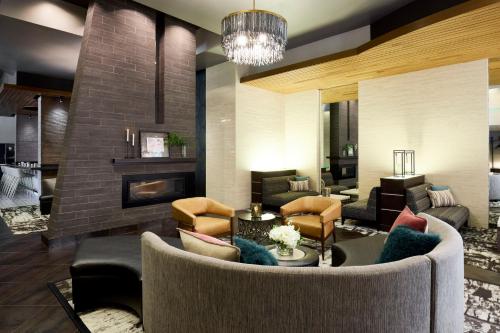 Una sala de estar con un sofá y una chimenea. en Archer Hotel Falls Church, en Fairfax